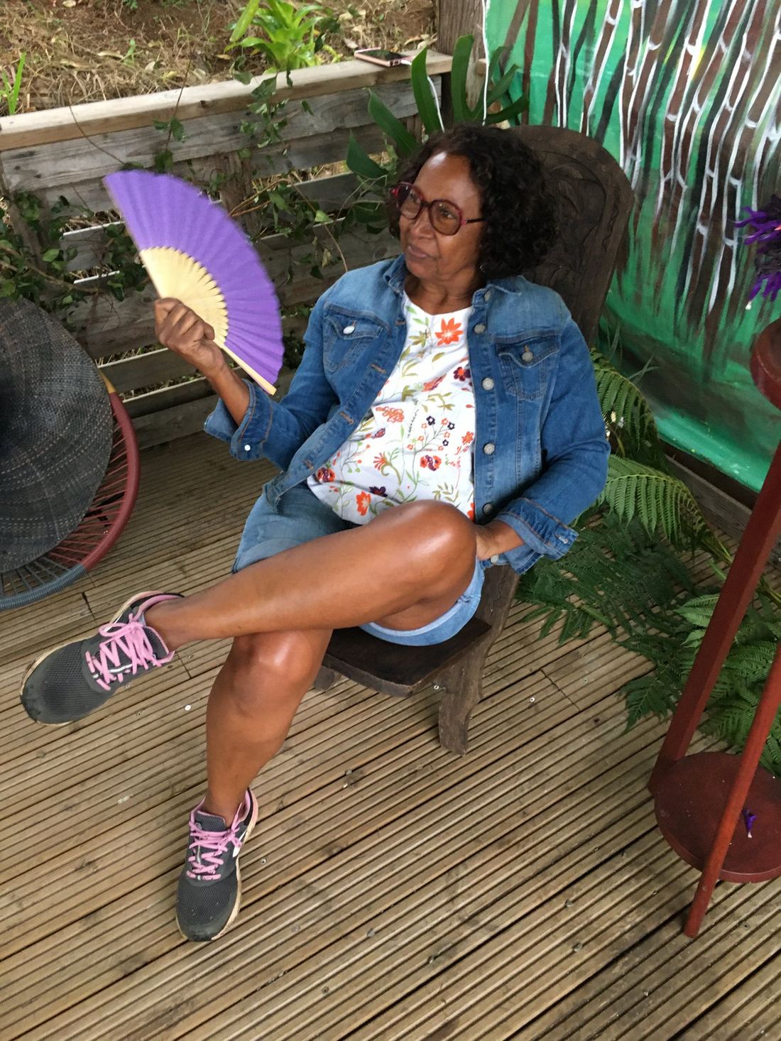 A guest with a fan, seated in a denim jacket