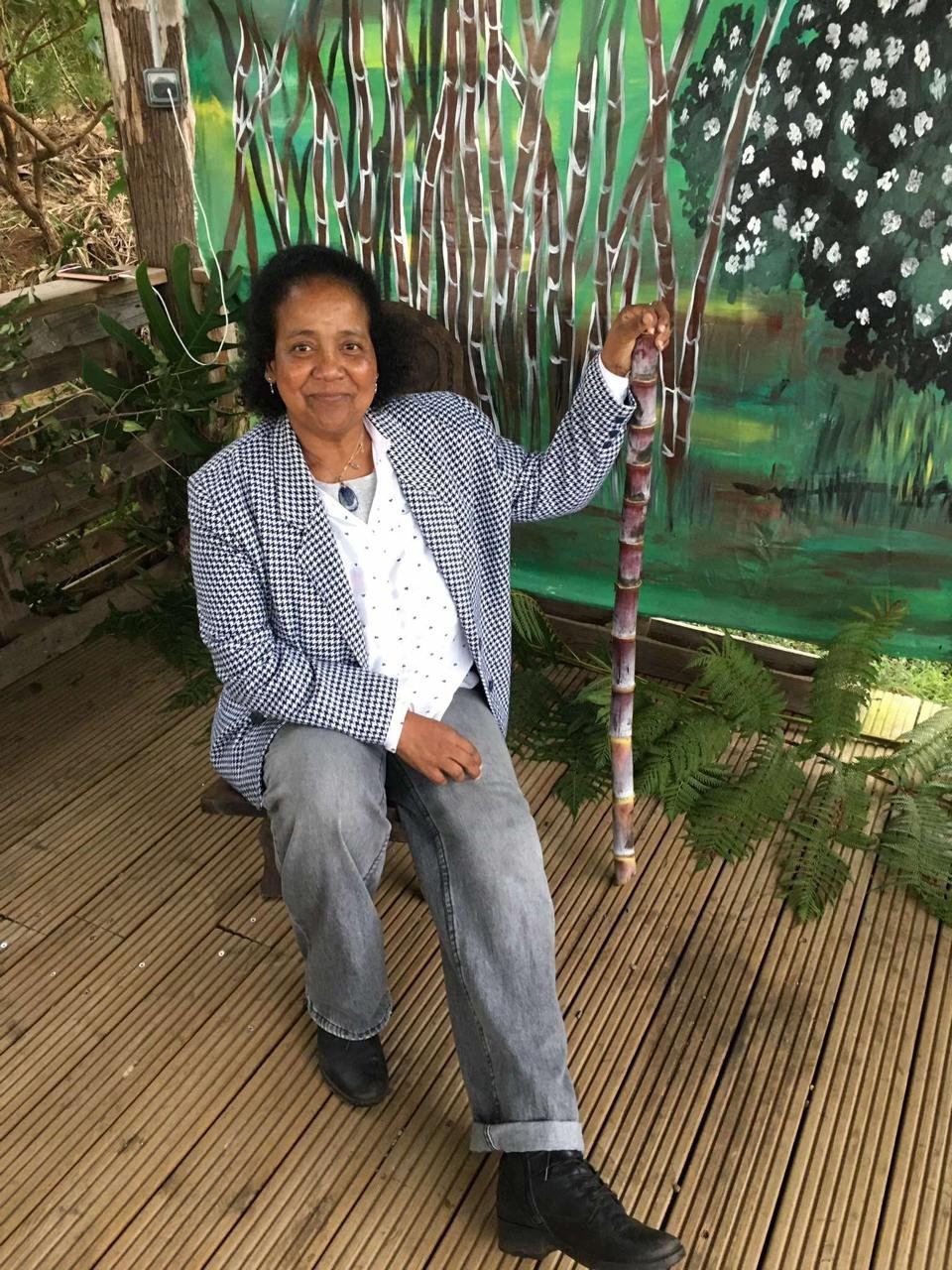 A guest seated in front of a painted mural