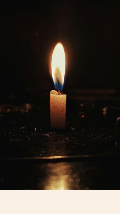 A single candle in the dark — mood reference