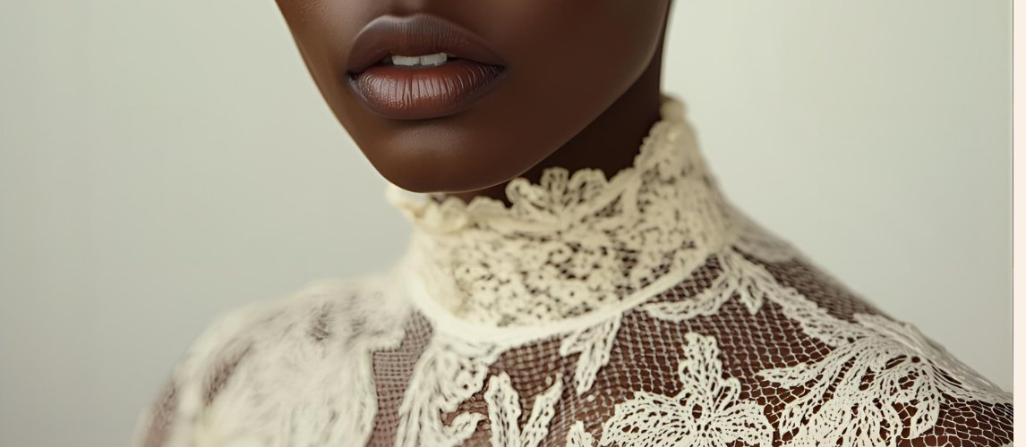 Close, candlelit study of lace against skin
